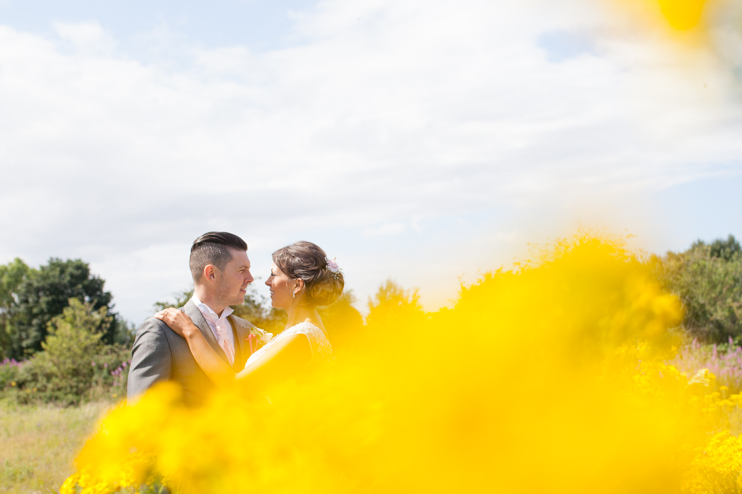 bride and groom in yellow flowers